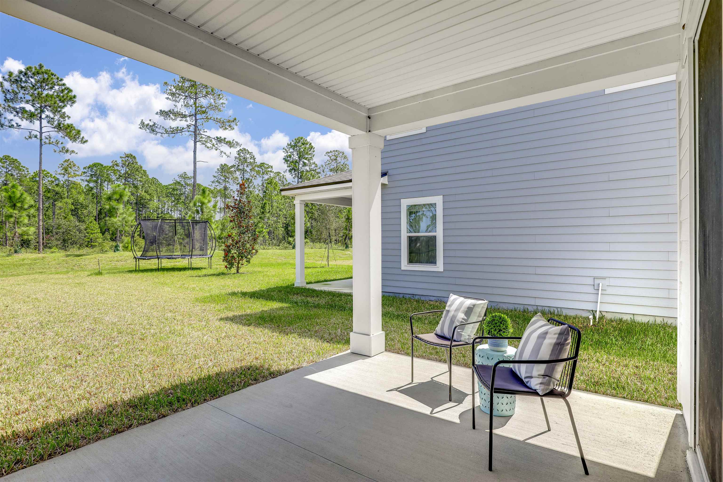 333 Bermudez Way St. Augustine, FL 32095 - Photo 39 of 62 a patio with table and chairs and potted plants