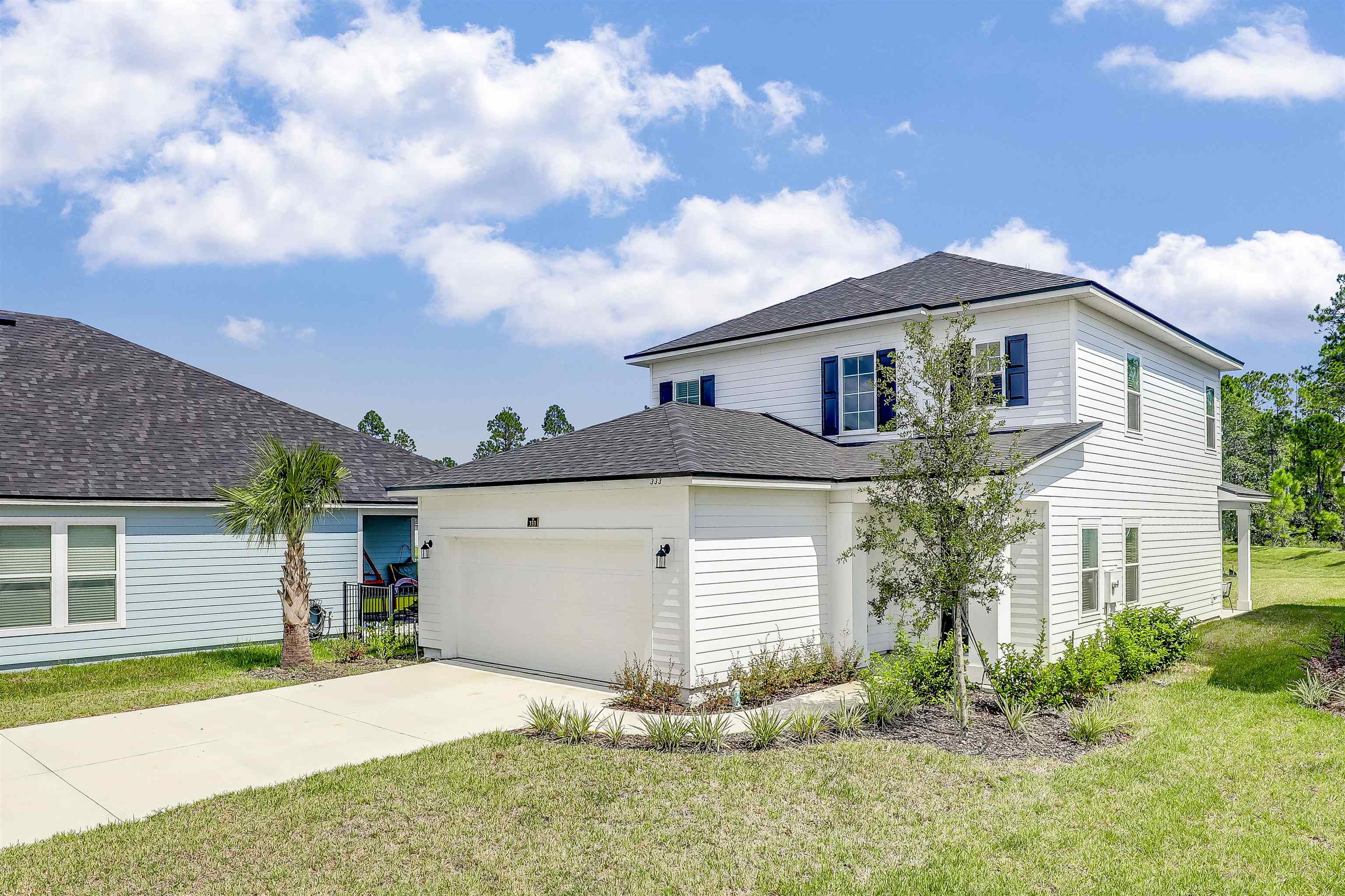 333 Bermudez Way St. Augustine, FL 32095 - Photo 62 of 62 a front view of a house with a yard and garage