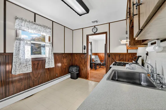 a kitchen with stainless steel appliances granite countertop a sink and a refrigerator