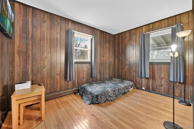 a bedroom with a bed and a mirror