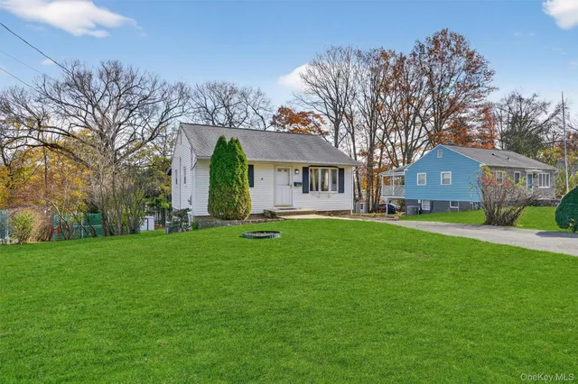 a front view of house with yard and green space