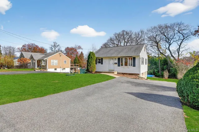 a view of a white house with a yard and chandelier