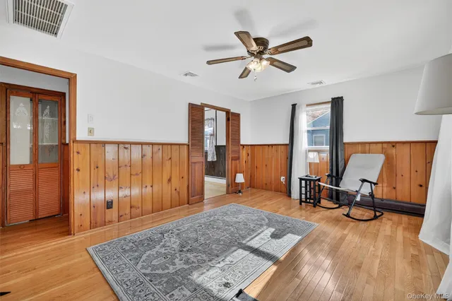 a view of a hallway with workspace and wooden floor