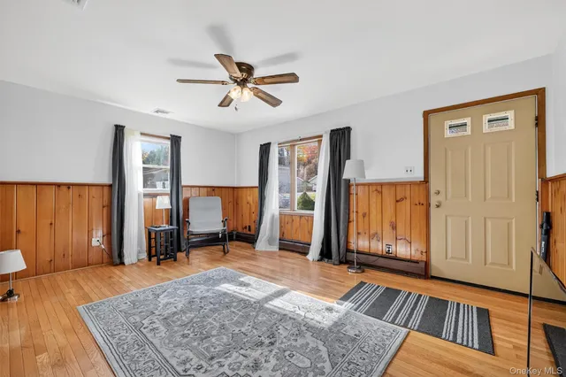 a view of a bedroom with furniture and window