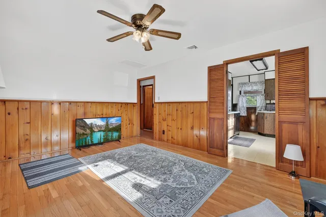 a living room with a flat screen tv and a rug