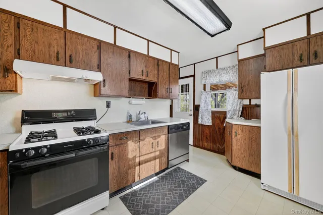 a kitchen with stainless steel appliances a refrigerator sink and stove