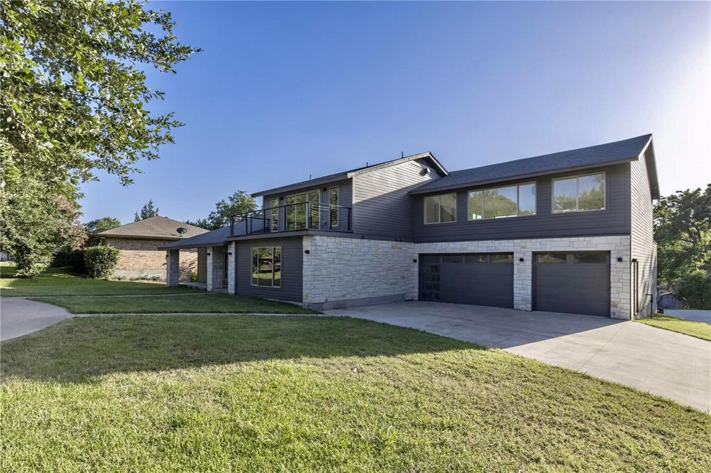 1408 South Alamo Road Rockwall, TX 75087 - Photo 10 of 40 a front view of a house with a yard and garage