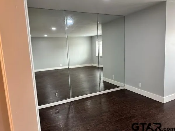 an empty room with wooden floor