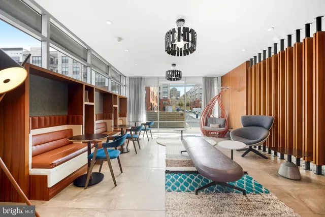 a living room with patio furniture and a floor to ceiling window