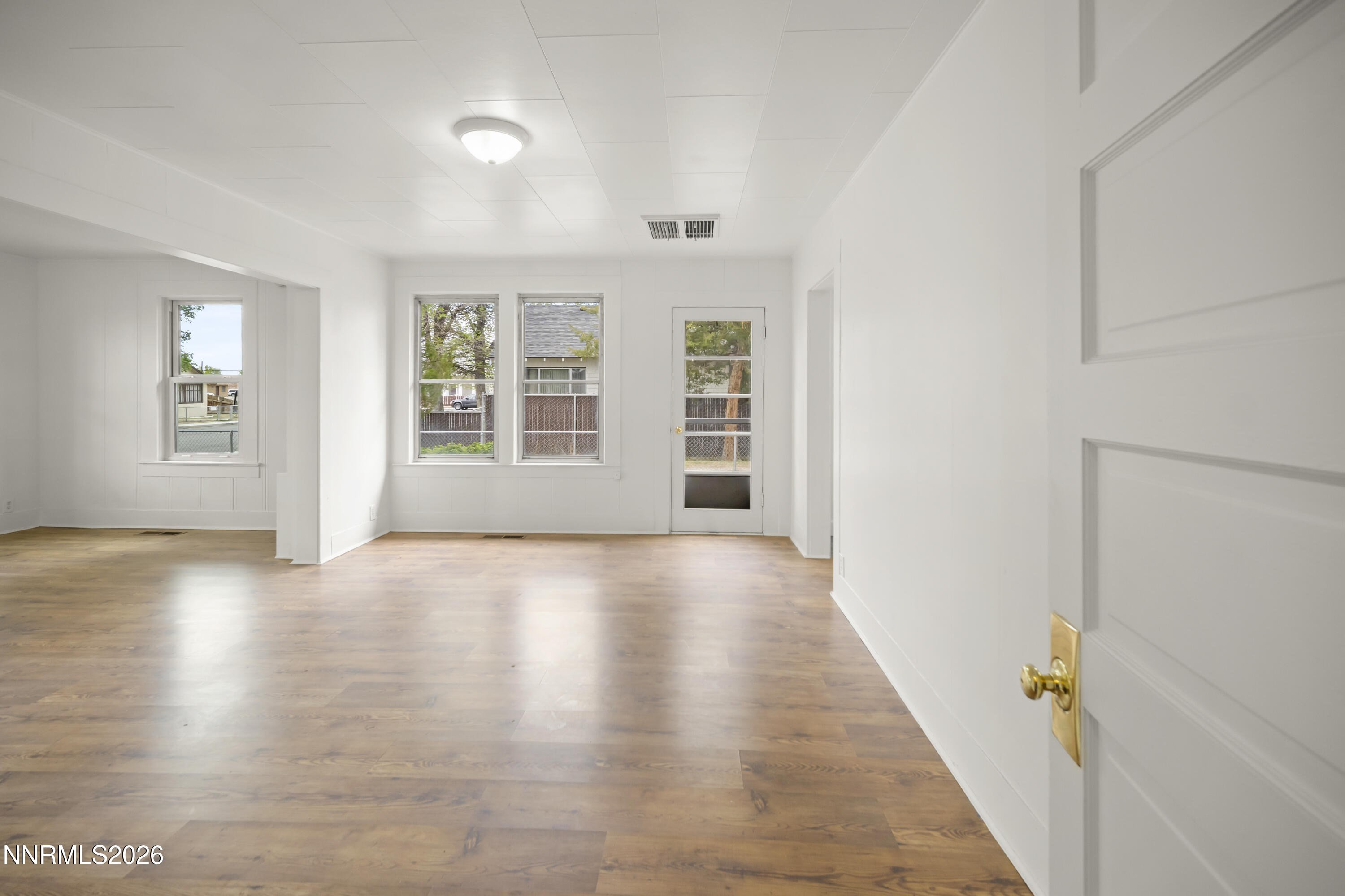 511 Churchill Street Fallon, NV 89406 - Photo 17 of 37 an empty room with wooden floor and windows