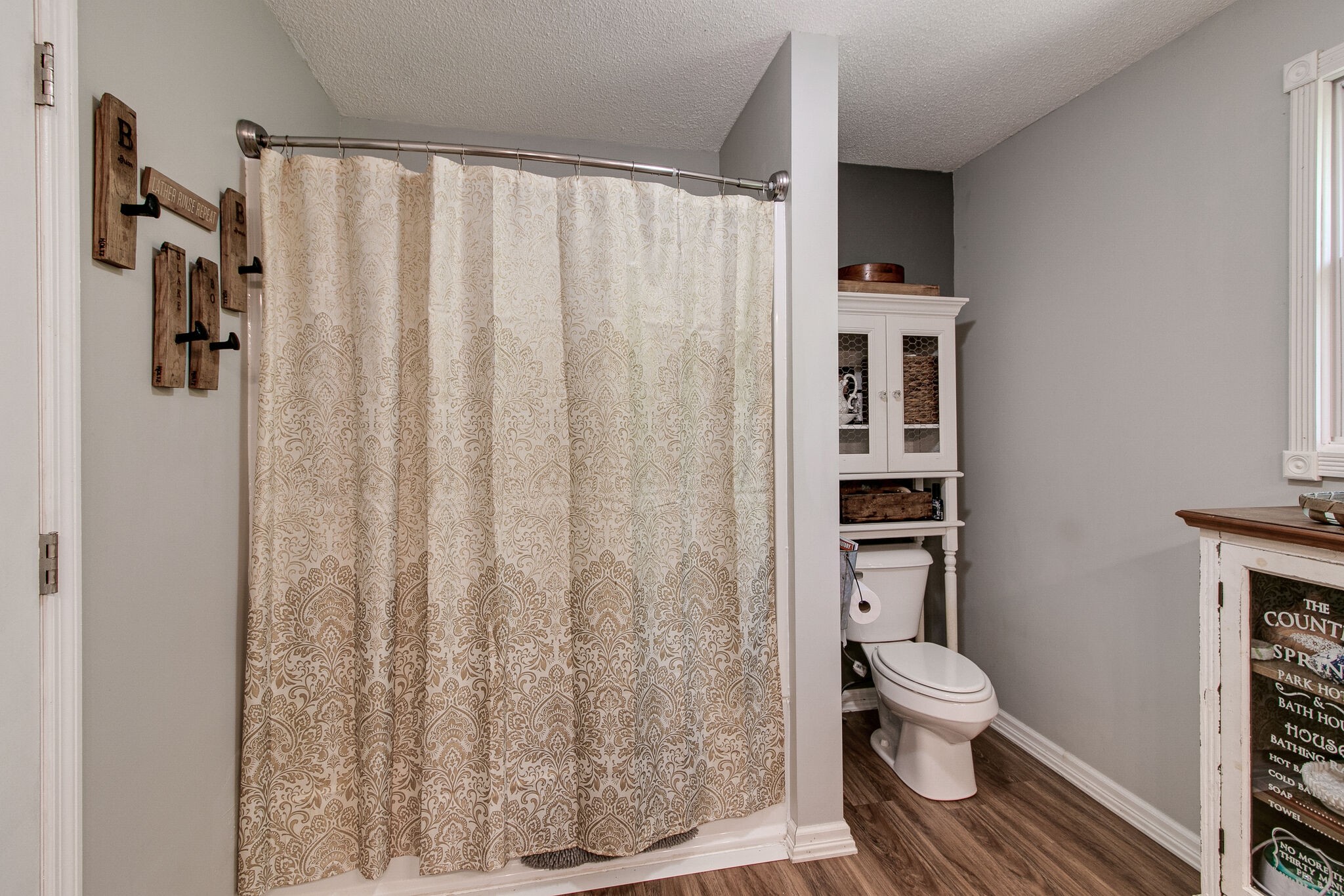 351 Dean Road Clarksville, TN 37040 - Photo 29 of 39 a white toilet sitting next to a bathroom sink and curtain