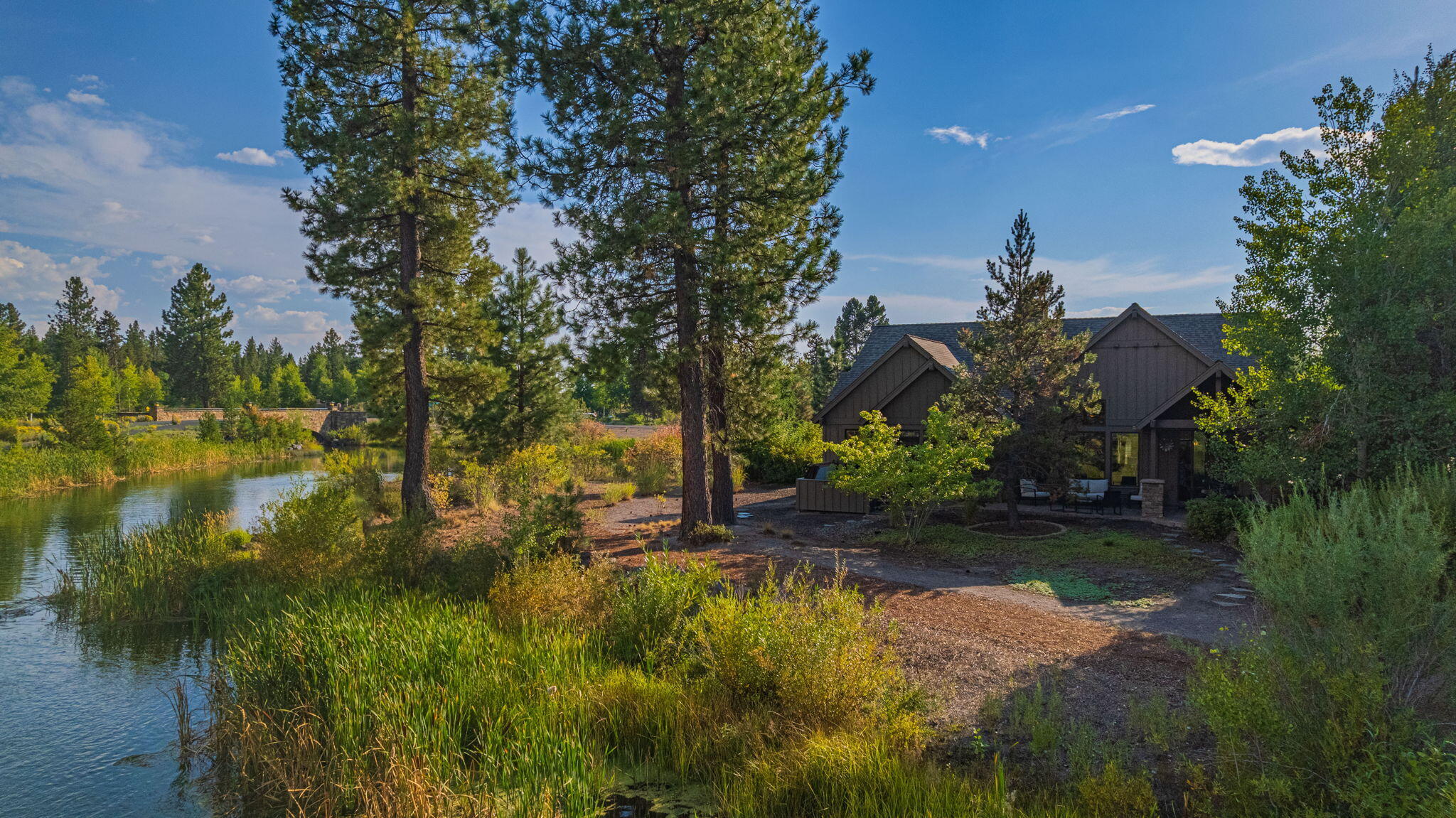 56508 Dancing Rock Loop, Unit 22 Bend, OR 97707 - Photo 1 of 69 a backyard of a house with lots of green space