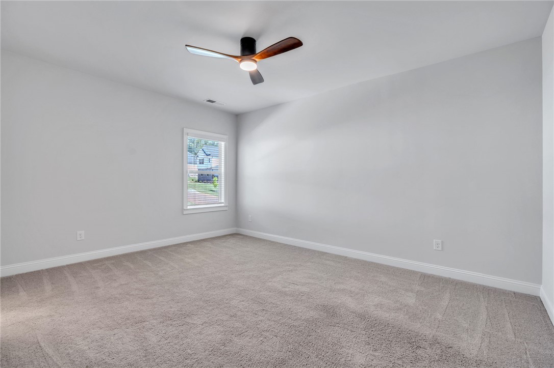 226 Holly Br Road Piedmont, SC 29673 - Photo 32 of 44 A well-lit bedroom with soft carpet, offering comfortable living space and an airy feel.