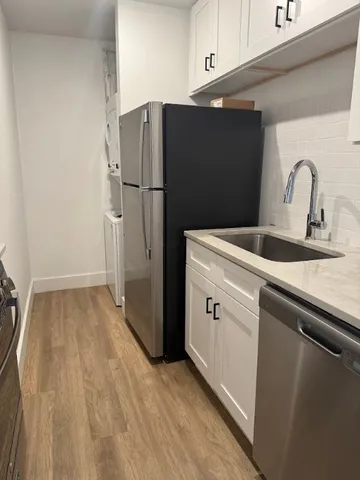 a kitchen with a refrigerator and a sink