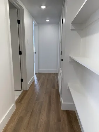 a view of hallway with wooden floor