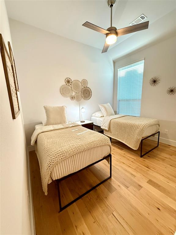 1835 Bell Court Van Alstyne, TX 75495 - Photo 14 of 20 a bedroom with two beds and a chandelier