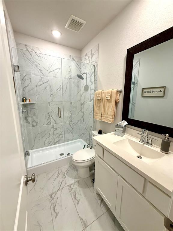 1835 Bell Court Van Alstyne, TX 75495 - Photo 15 of 20 a bathroom with a double vanity sink toilet mirror and shower