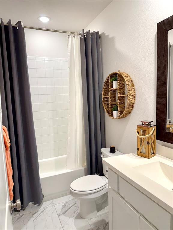 1835 Bell Court Van Alstyne, TX 75495 - Photo 16 of 20 a bathroom with a sink a toilet and a mirror