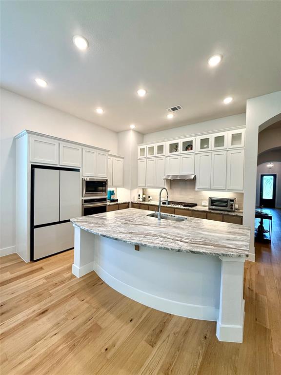 1835 Bell Court Van Alstyne, TX 75495 - Photo 7 of 20 a large kitchen with kitchen island a stove a sink a refrigerator and a counter space