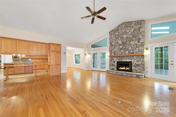 a view of empty room with wooden floor and fireplace