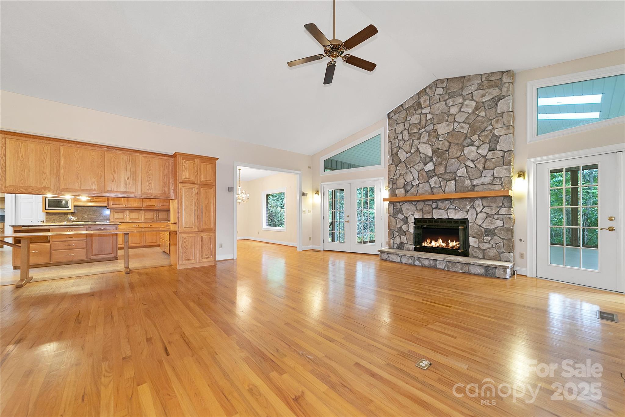273 Inoli Circle Brevard, NC 28712 - Photo 11 of 47 a view of empty room with wooden floor and fireplace