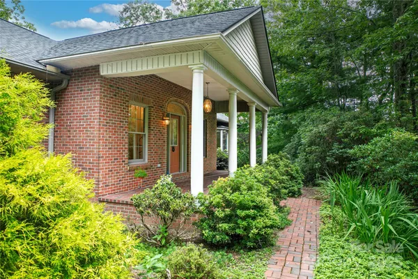 a view of a small house with potted plants