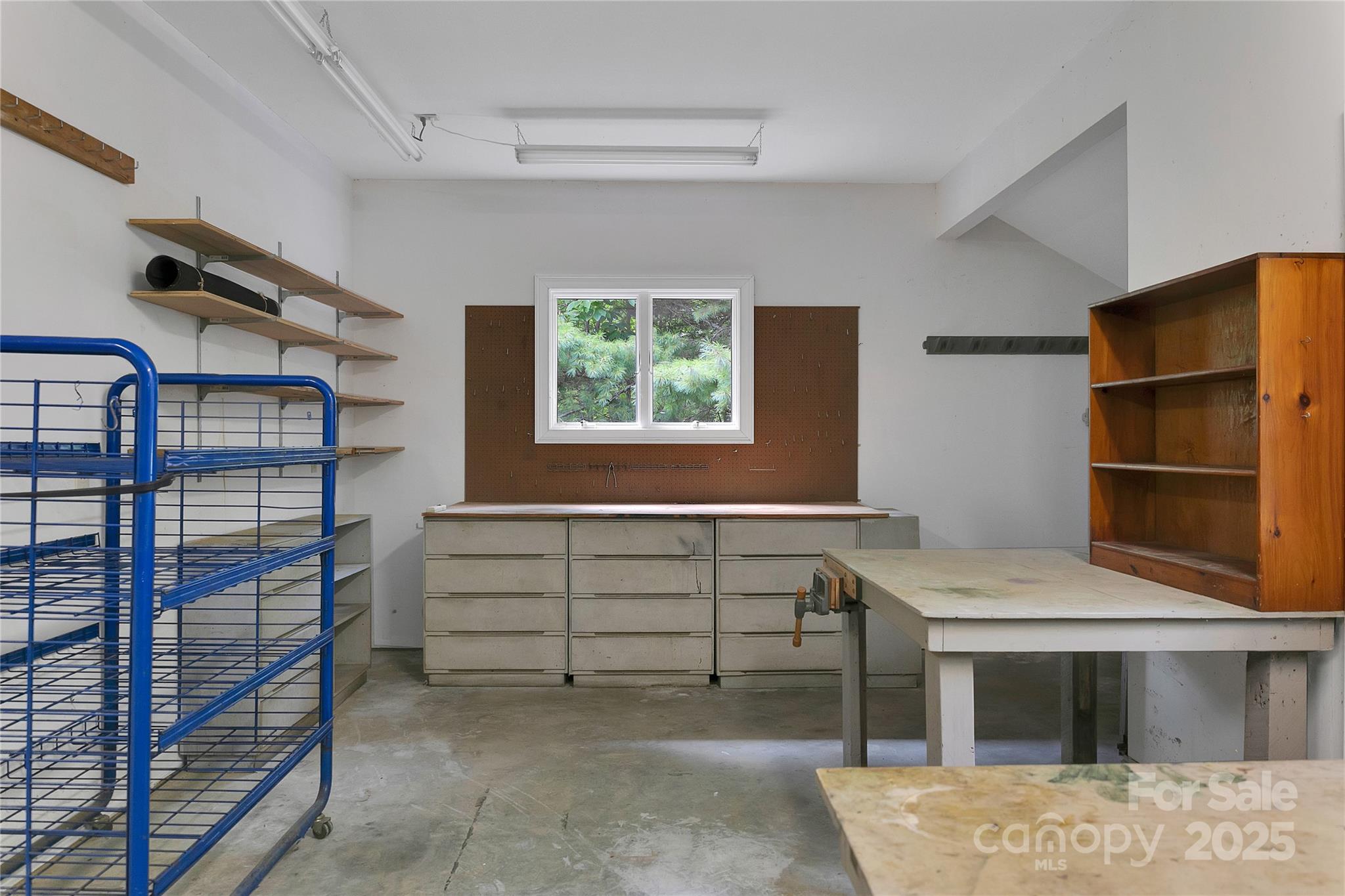 273 Inoli Circle Brevard, NC 28712 - Photo 27 of 47 a view of an empty room with a fireplace and a window