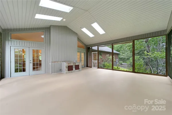 a view of an empty room with windows and a balcony