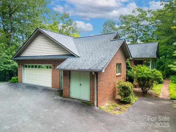 a front view of a house with a garden and garage