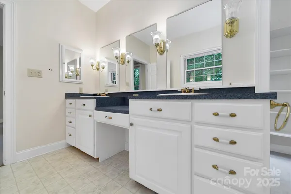 a kitchen with cabinets appliances a sink and a window