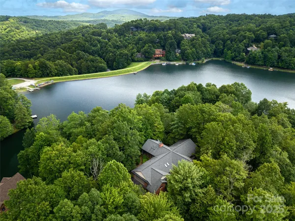 an aerial view of a house with a yard basket ball court and outdoor seating