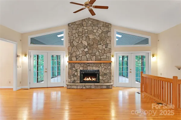 a living room with a fireplace and wooden floor