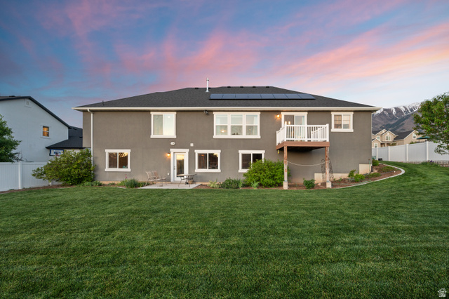 1145 North Christley Lane, Unit 48 Elk Ridge, UT 84651 - Photo 31 of 38 Expansive backyard featuring a manicured lawn, a concrete patio, and a second-story balcony
