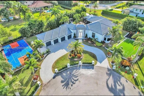 an aerial view of a house with a swimming pool