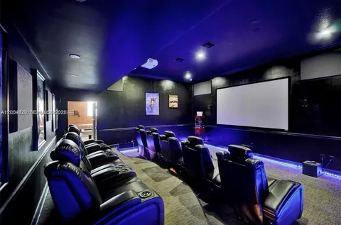 a room with furniture projector and screen