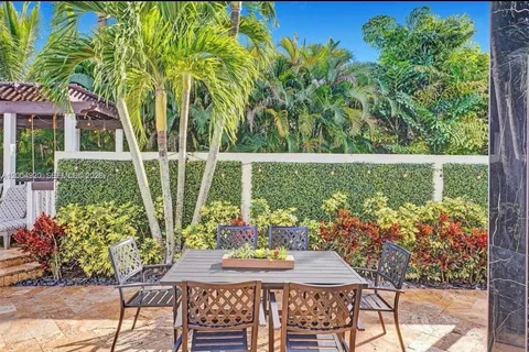 a view of a patio with couches chairs and potted plants