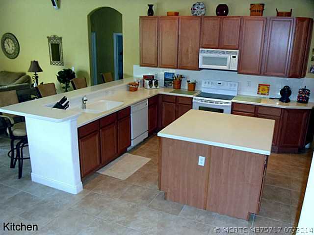 1909 Southwest Panther Trace Stuart, FL 34997 - Photo 8 of 25 Kitchen. Oversized island with loads of work space. Command central