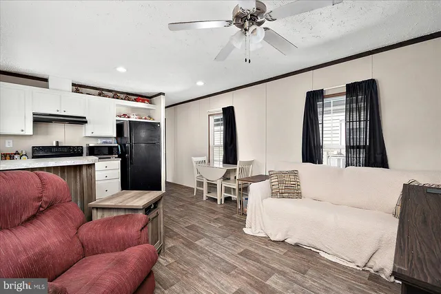a living room with furniture kitchen and a window