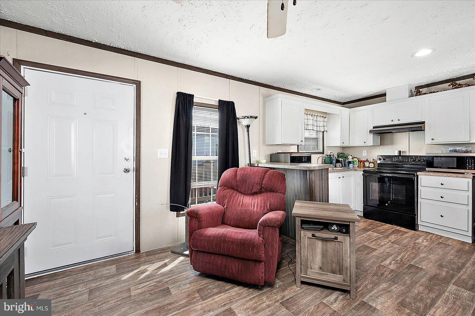 12346 Old Bridge Road, Unit 152 Ocean City, MD 21842 - Photo 13 of 55 a kitchen with stainless steel appliances granite countertop a refrigerator and a stove top oven