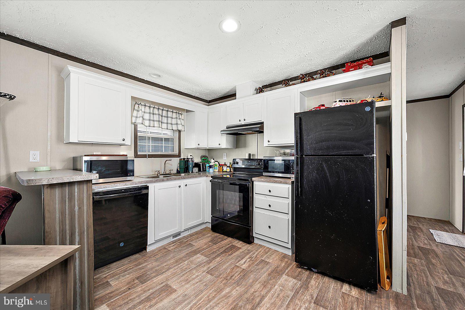 12346 Old Bridge Road, Unit 152 Ocean City, MD 21842 - Photo 14 of 55 a kitchen with a refrigerator and a sink