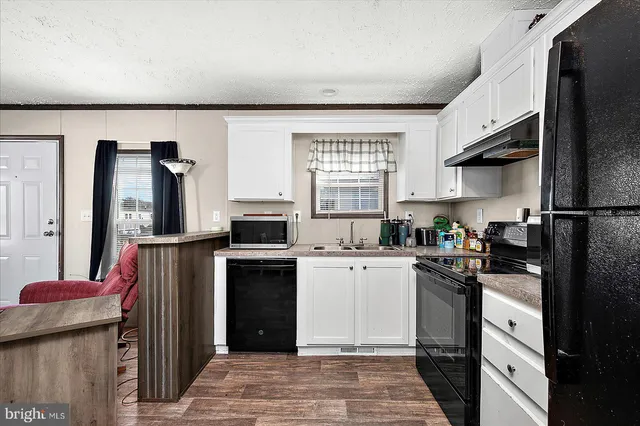 a kitchen with a sink a stove and refrigerator