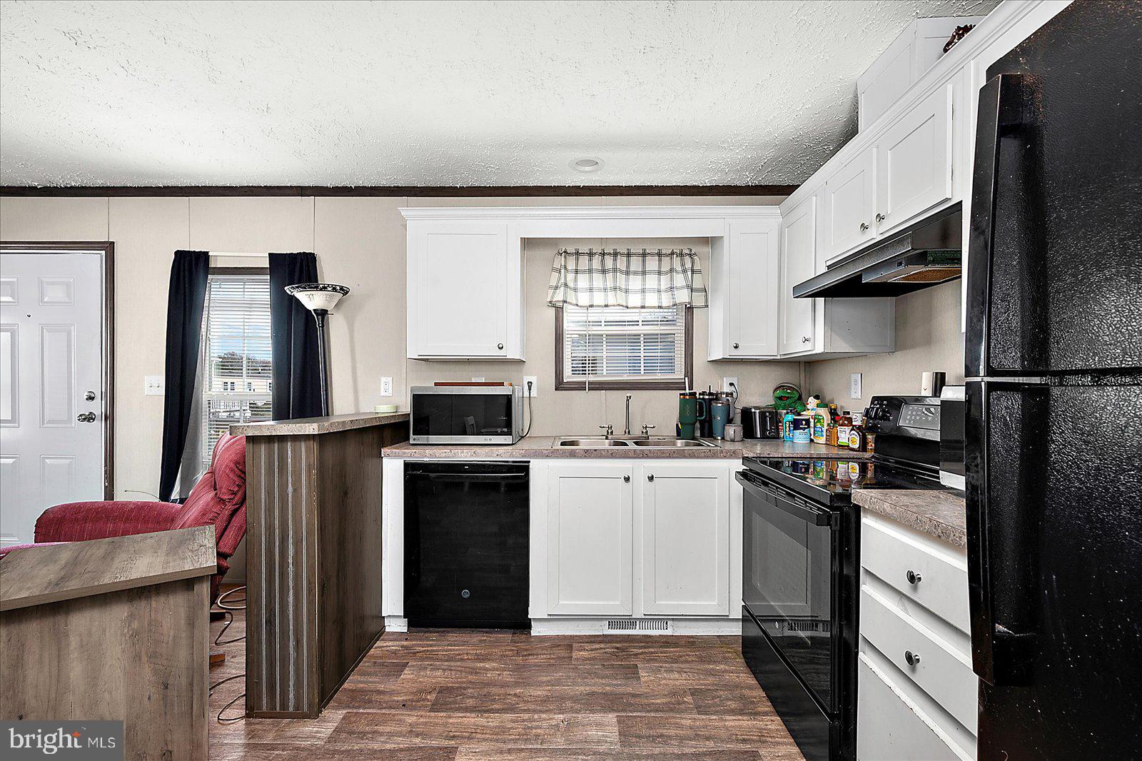 12346 Old Bridge Road, Unit 152 Ocean City, MD 21842 - Photo 15 of 55 a kitchen with a sink a stove and refrigerator