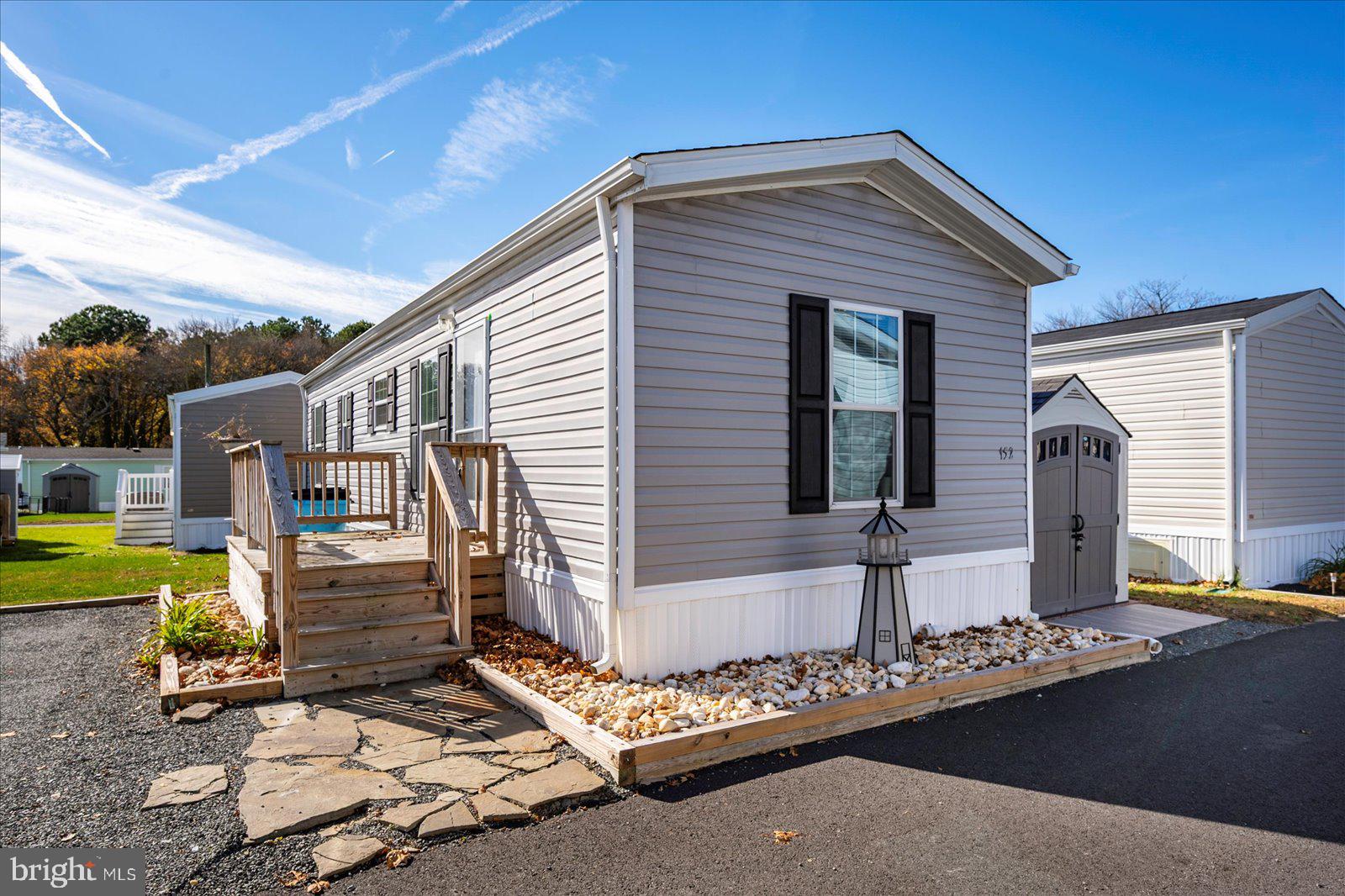 12346 Old Bridge Road, Unit 152 Ocean City, MD 21842 - Photo 2 of 55 a front view of a house with garden