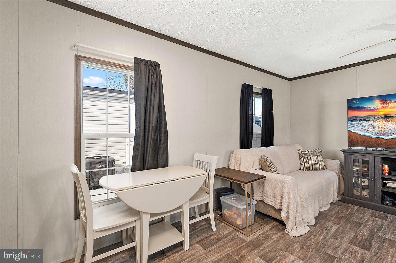 12346 Old Bridge Road, Unit 152 Ocean City, MD 21842 - Photo 21 of 55 a living room with furniture and a flat screen tv