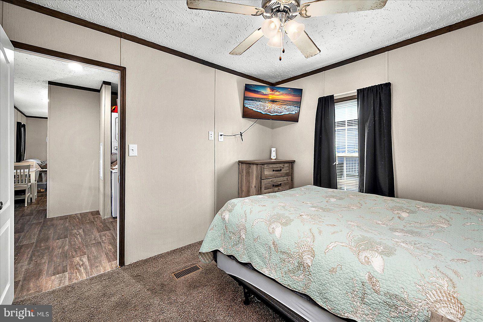 12346 Old Bridge Road, Unit 152 Ocean City, MD 21842 - Photo 23 of 55 a bedroom with a bed and a chandelier