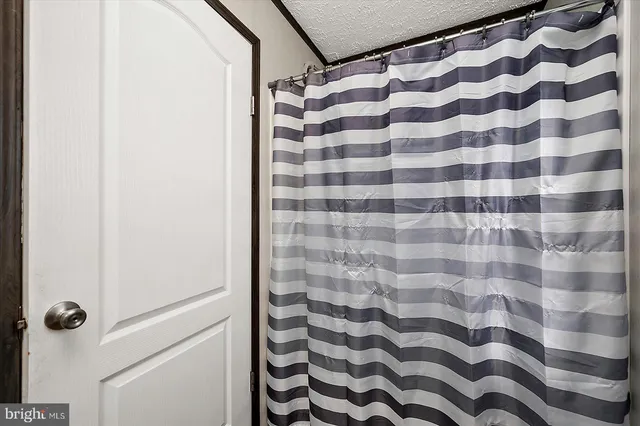 a bathroom with a black and white checkered floor