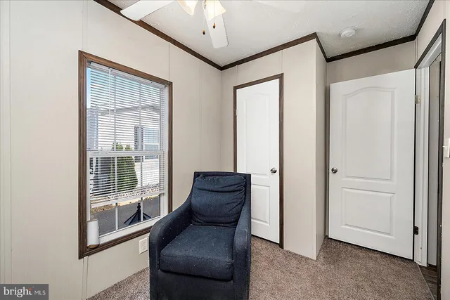 a view of a hallway with furniture and windows