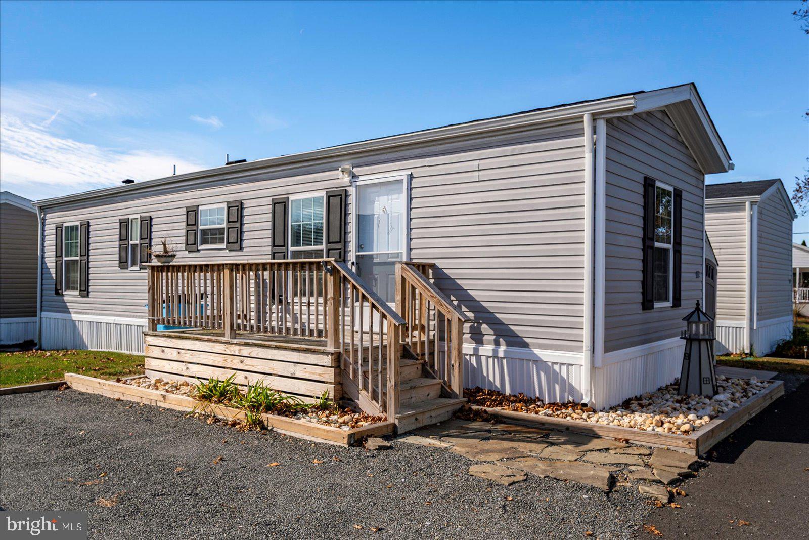 12346 Old Bridge Road, Unit 152 Ocean City, MD 21842 - Photo 33 of 55 a view of a house with a small yard and wooden fence