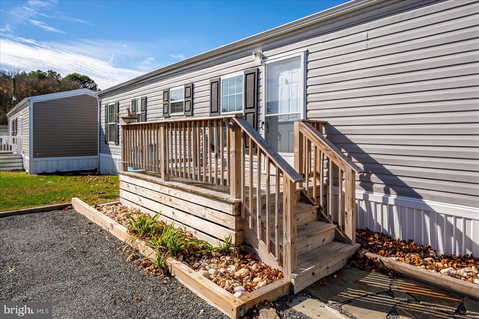 12346 Old Bridge Road, Unit 152 Ocean City, MD 21842 - Photo 34 of 55 a view of a house with wooden floor roof and wooden fence