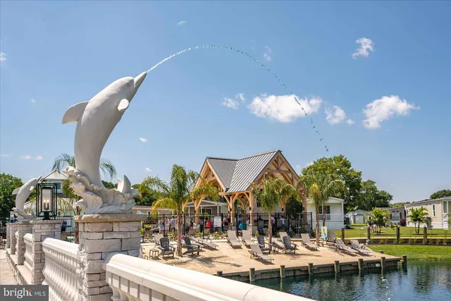 a front view of multi story residential apartment building and car parked on street